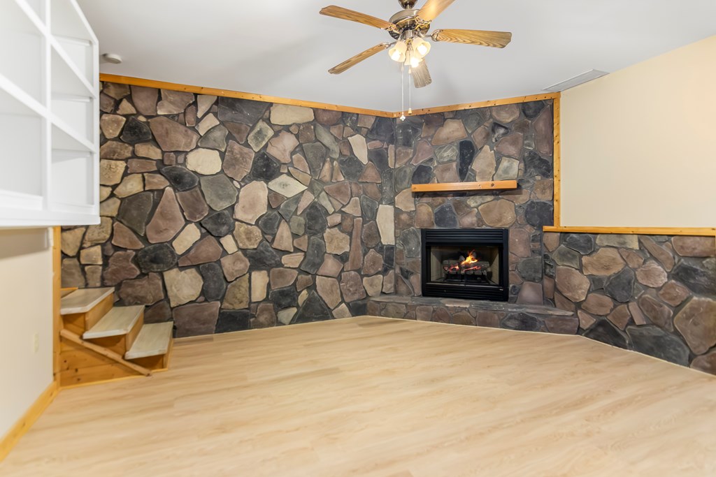 125 Waters Road Ellijay, GA 30536 - Photo 27 of 68 a bedroom with a bed and a fireplace