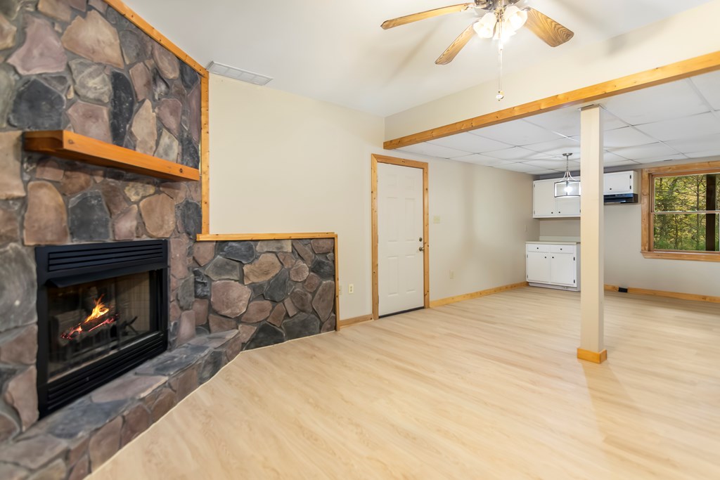 125 Waters Road Ellijay, GA 30536 - Photo 28 of 68 a bedroom with a bed and a fireplace