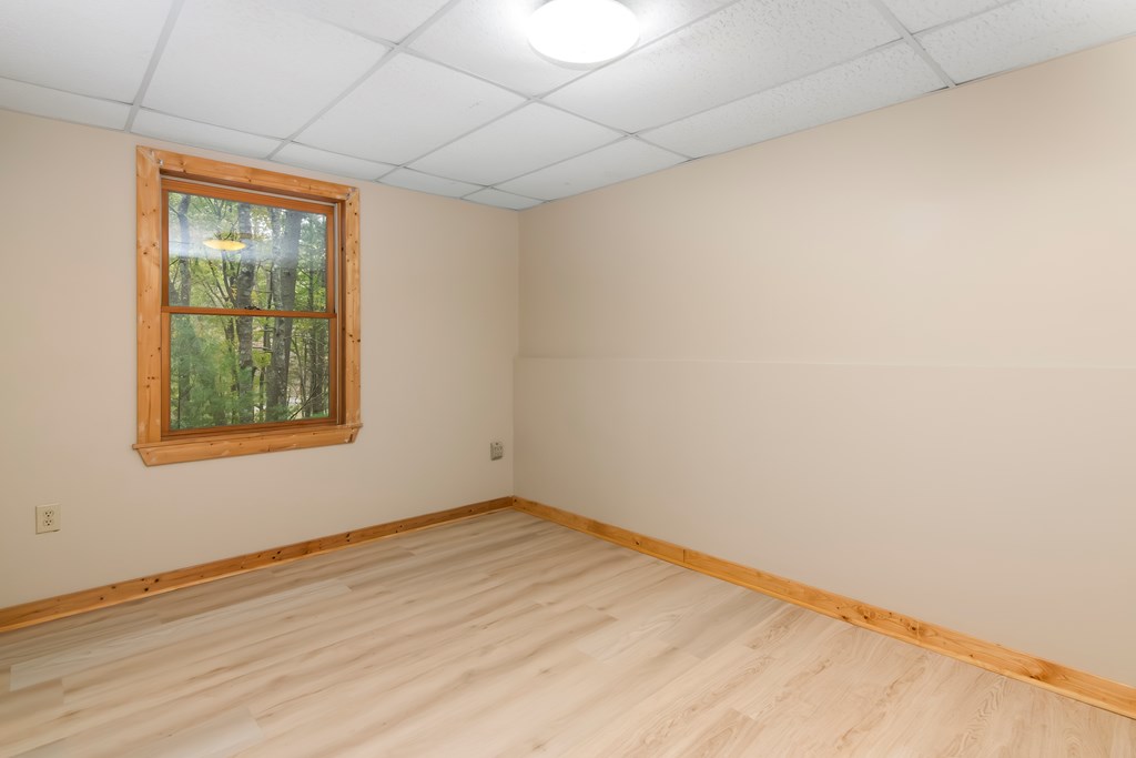 125 Waters Road Ellijay, GA 30536 - Photo 34 of 68 a view of an empty room with wooden floor and a window