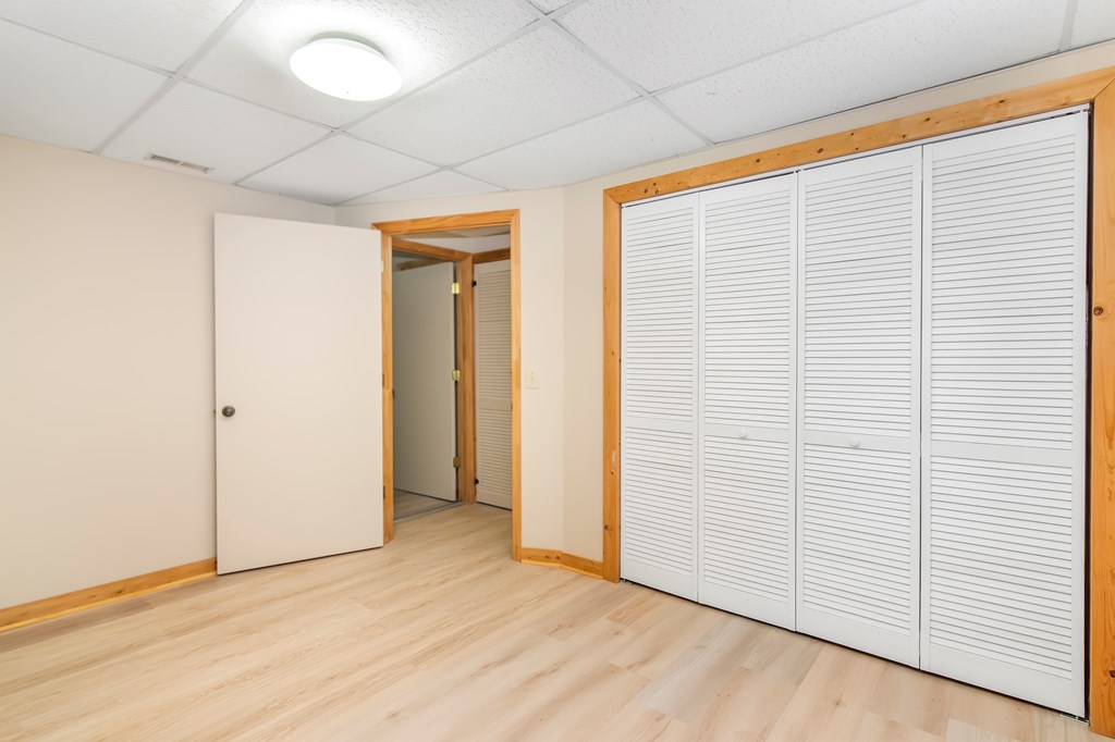 125 Waters Road Ellijay, GA 30536 - Photo 36 of 68 an empty room with wooden floor and white walls