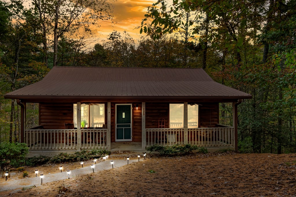125 Waters Road Ellijay, GA 30536 - Photo 45 of 68 a view of a brick house next to a large tree