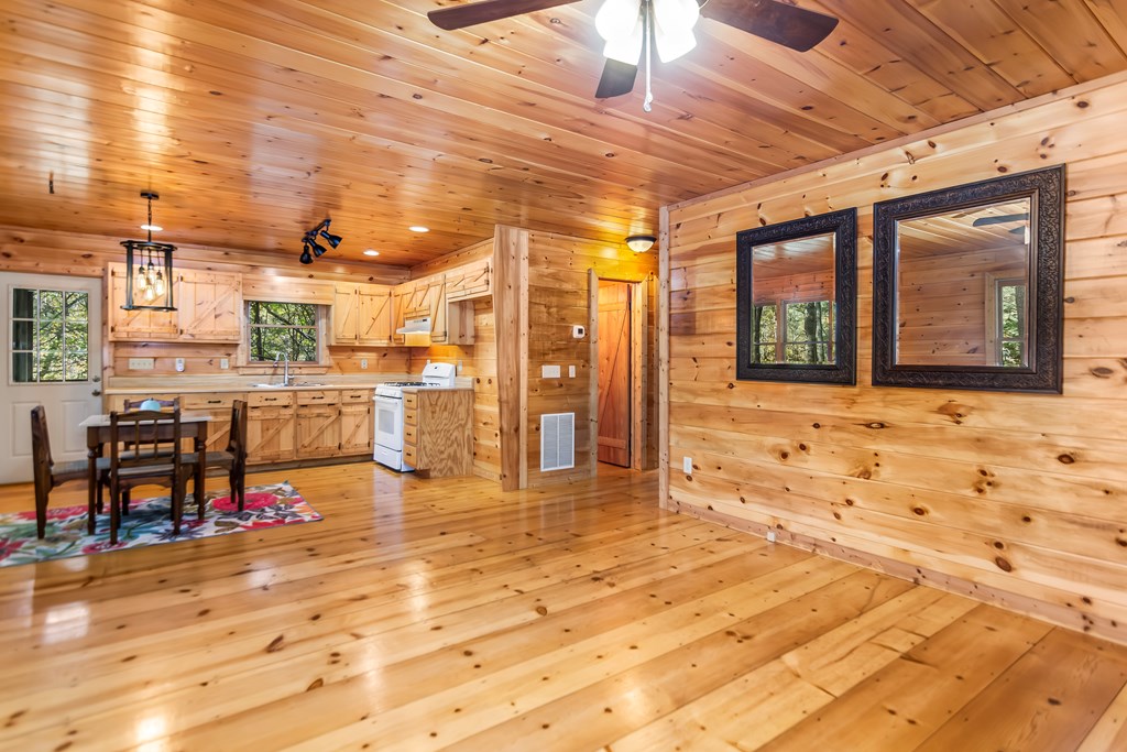 125 Waters Road Ellijay, GA 30536 - Photo 7 of 68 a view of a living room with stainless steel appliances kitchen island granite countertop a sink and cabinets