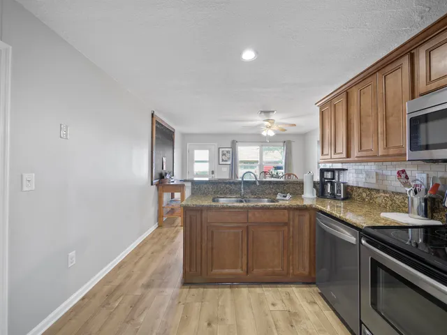 a kitchen with a sink stove and cabinets