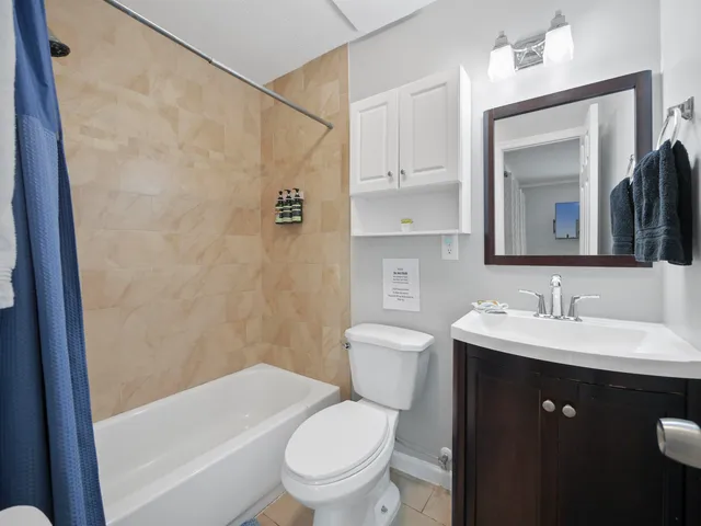 a bathroom with a toilet a sink a vanity and mirror