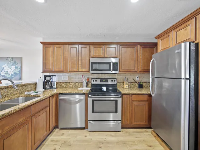 a kitchen with a sink stove and refrigerator