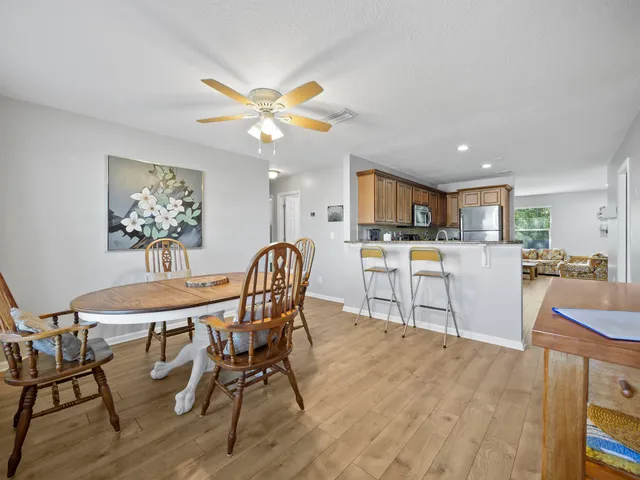 a view of a dining room with furniture and a chandelier
