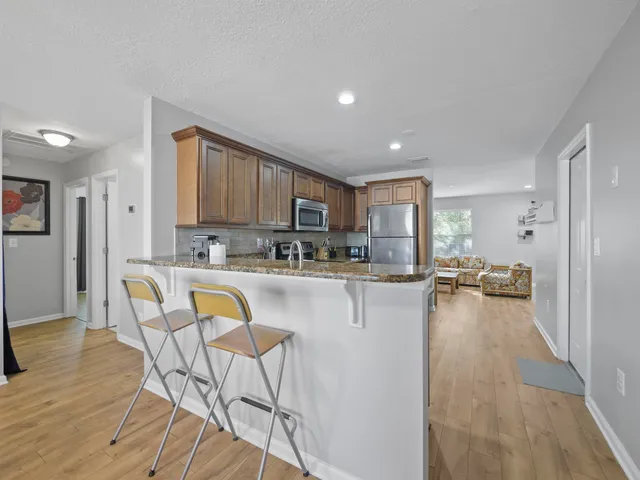 a kitchen with dining table and chairs
