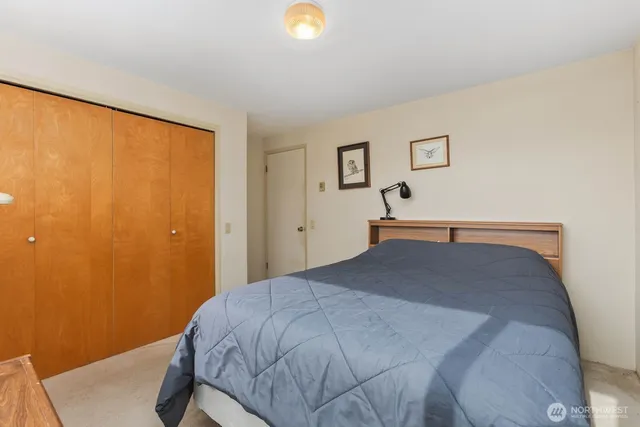 a bedroom with a bed and a lamp on the table