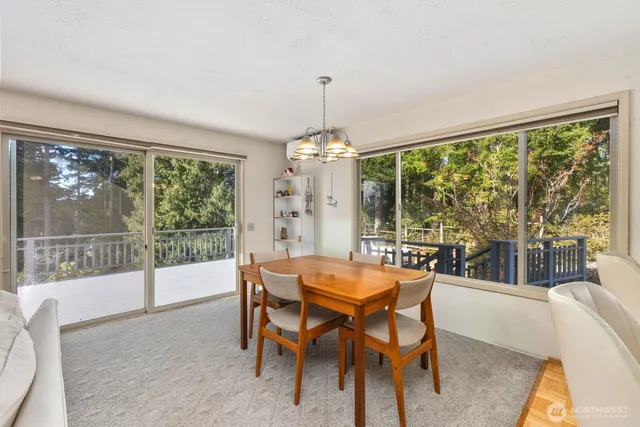 a dining room with furniture a chandelier and wooden floor