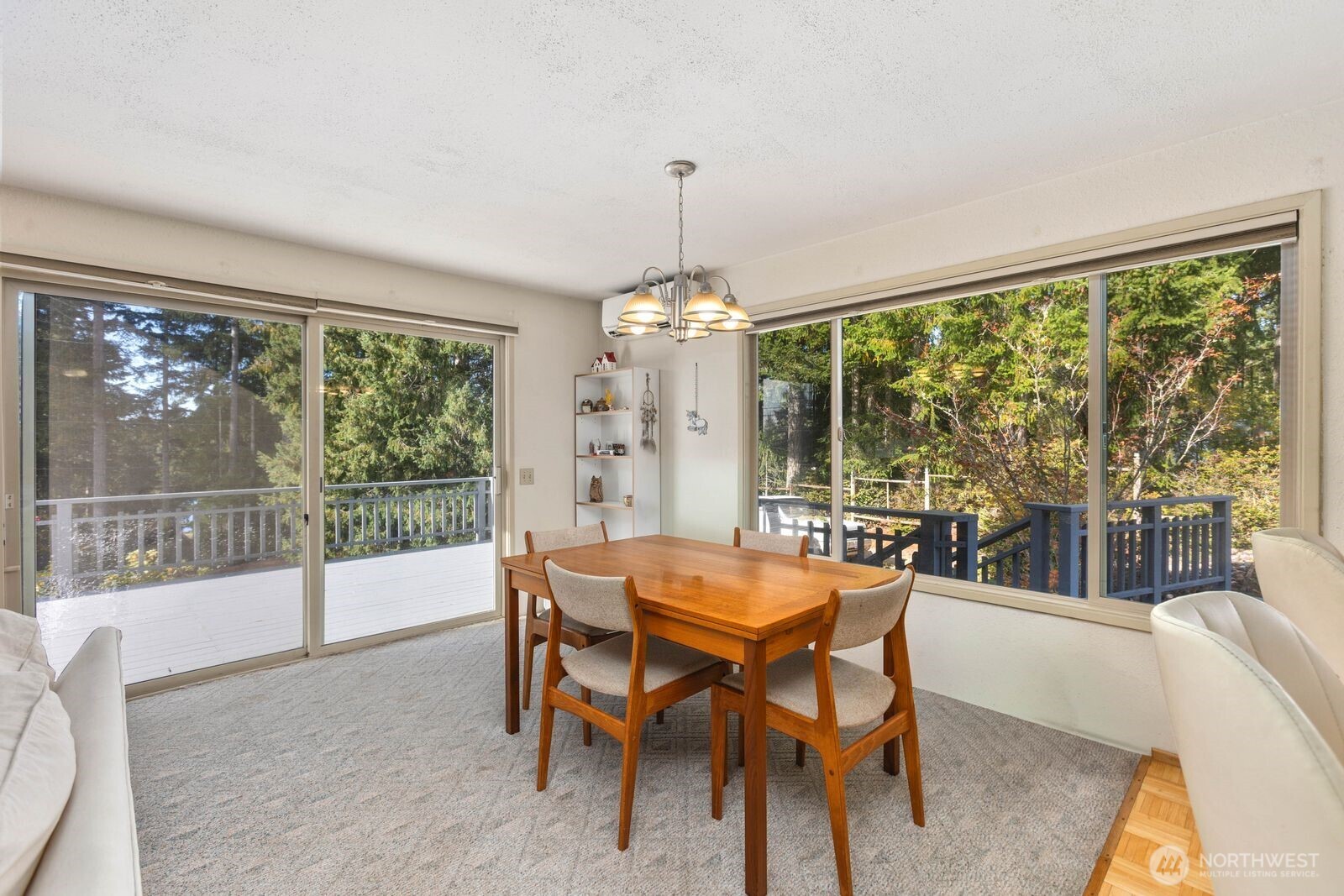 350 East Olympic Drive Grapeview, WA 98546 - Photo 17 of 40 a dining room with furniture a chandelier and wooden floor