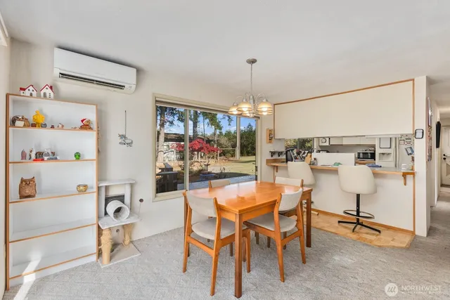 a view of a dining room with furniture and chandelier