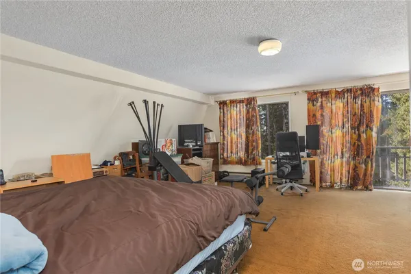 a bed room with two bed and a large window