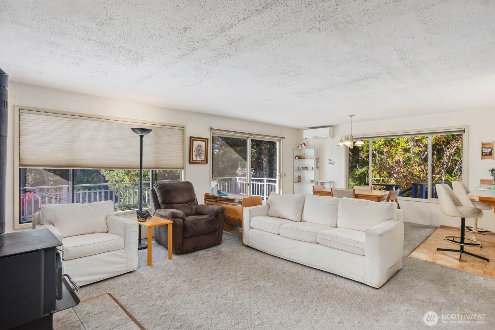 350 East Olympic Drive Grapeview, WA 98546 - Photo 22 of 40 a living room with furniture and a large window