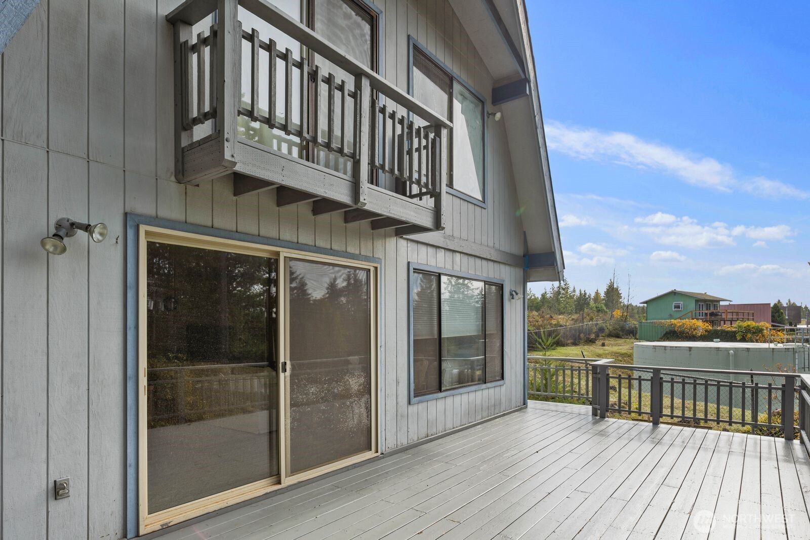 350 East Olympic Drive Grapeview, WA 98546 - Photo 29 of 40 a view of a balcony with wooden floor and city view