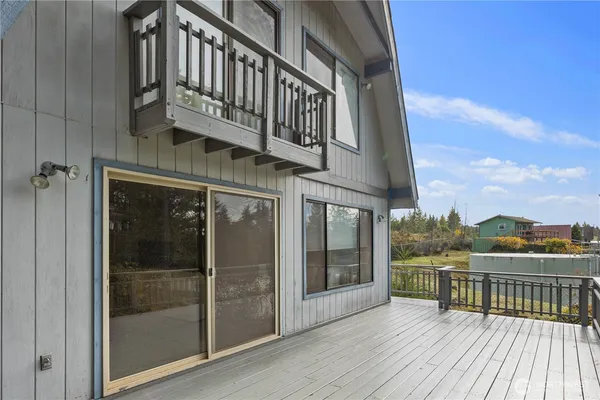 a view of a balcony with wooden floor and city view