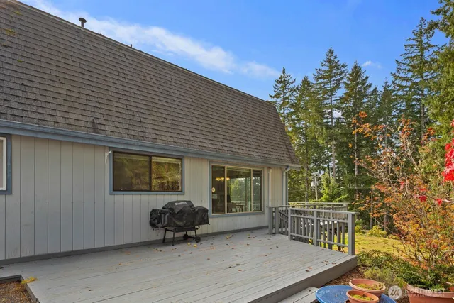a backyard of a house with barbeque oven and outdoor seating