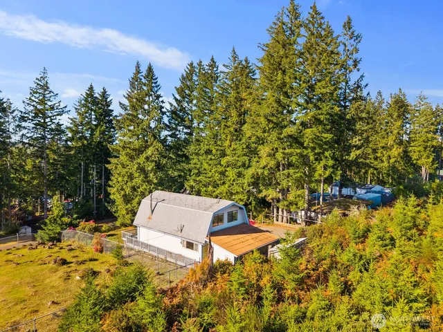 an aerial view of a house with a yard and garden