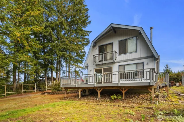 a backyard of a house with swimming pool table and chairs