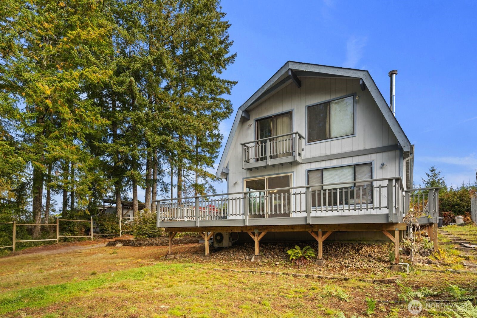 350 East Olympic Drive Grapeview, WA 98546 - Photo 4 of 40 a backyard of a house with swimming pool table and chairs