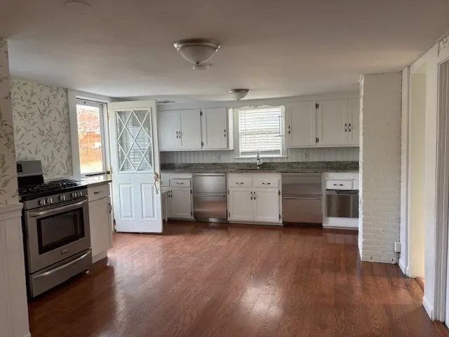 a kitchen with stainless steel appliances and wooden cabinets