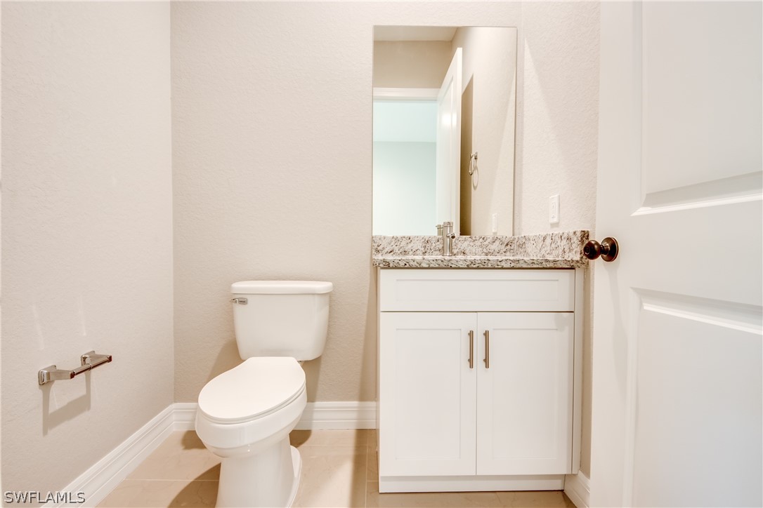 8201 Anhinga Road Fort Myers, FL 33967 - Photo 8 of 18 a bathroom with a toilet a sink and a mirror