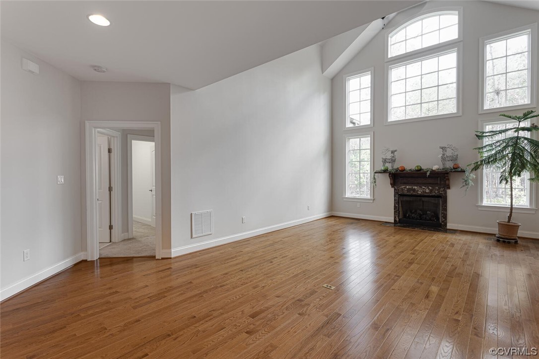 488 Bel Bridge Circle Midlothian, VA 23113 - Photo 14 of 38 an empty room with wooden floor fireplace and windows