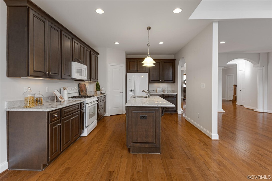 488 Bel Bridge Circle Midlothian, VA 23113 - Photo 21 of 38 a kitchen with stainless steel appliances granite countertop wooden cabinets a sink dishwasher a stove and a refrigerator with wooden floor