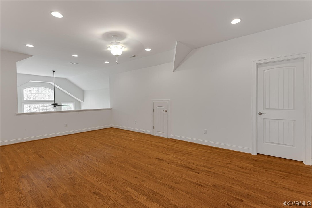 488 Bel Bridge Circle Midlothian, VA 23113 - Photo 31 of 38 a view of an empty room with wooden floor and a kitchen