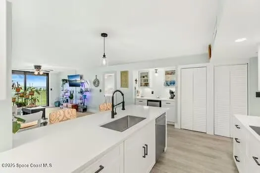 a kitchen with a sink a stove and cabinets