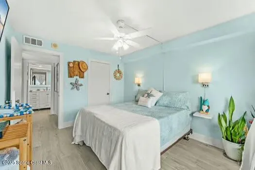 a bedroom with a bed and ceiling fan