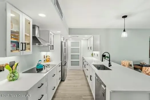 a kitchen with a sink a faucet and appliances