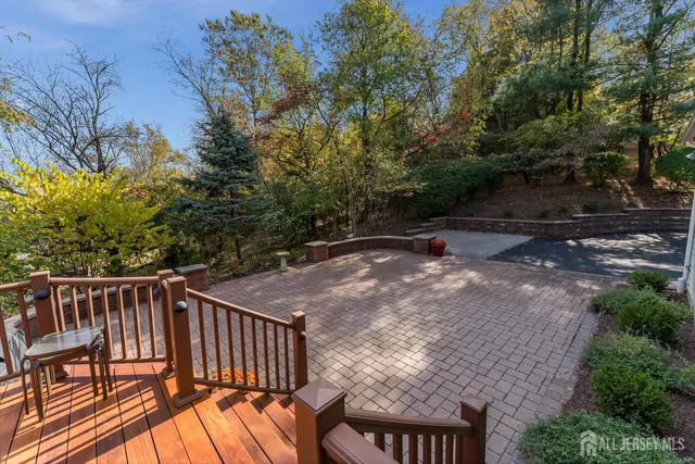 a view of a backyard with table and chairs and potted plants