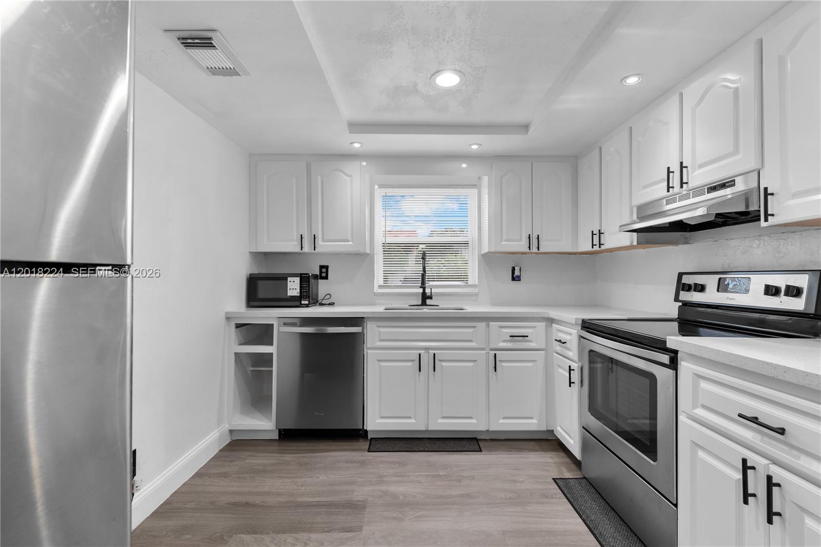 7958 Southwest 6th Street Pompano Beach, FL 33068 - Photo 16 of 57 a kitchen with a white cabinets and white appliances