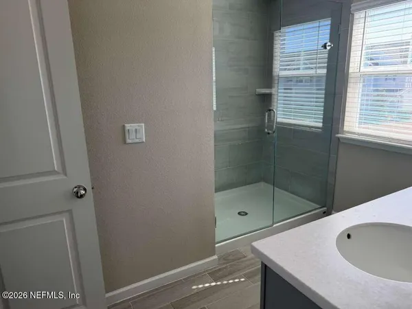 a bathroom with a bathtub and shower