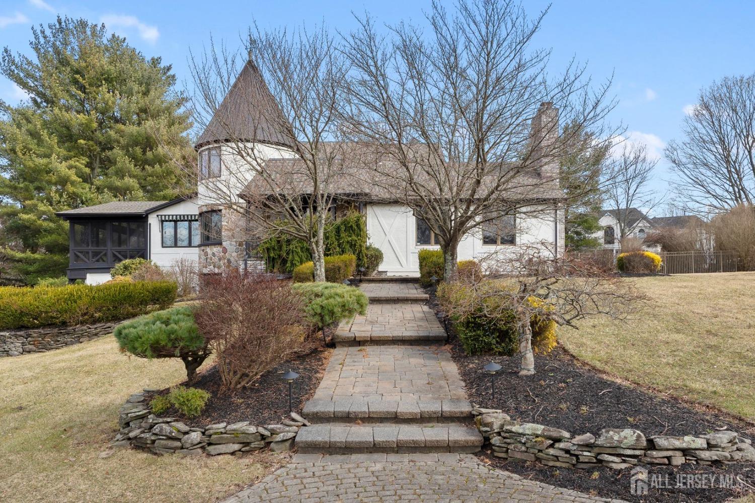 13 Eagle Nest Road Colts Neck, NJ 07722 - Photo 4 of 79 a front view of a house with a yard and garage