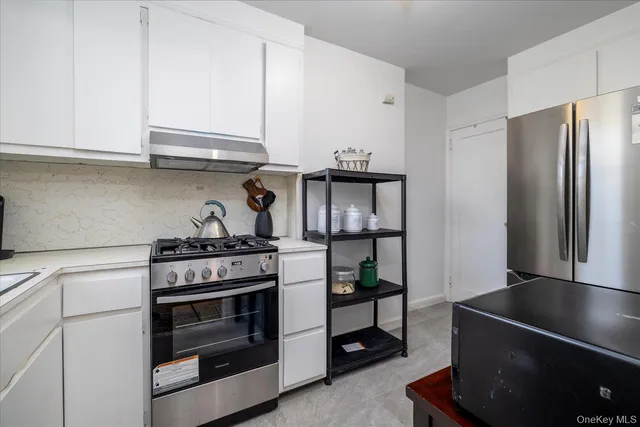a kitchen with stainless steel appliances granite countertop a stove and a refrigerator