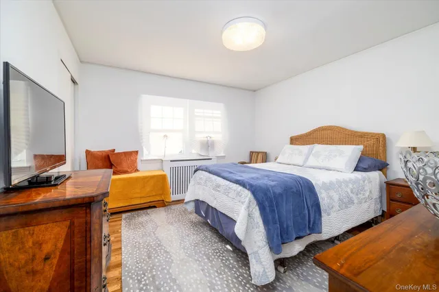 a bedroom with bed and a flat screen tv
