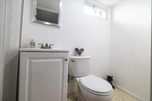 a white toilet sitting next to a bathroom sink