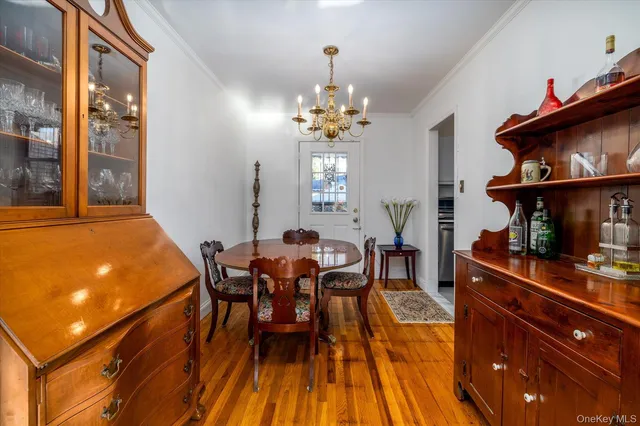 a view of a dining room with furniture and chandelier