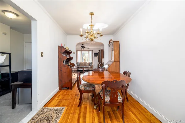 a view of a dining room with furniture and a chandelier