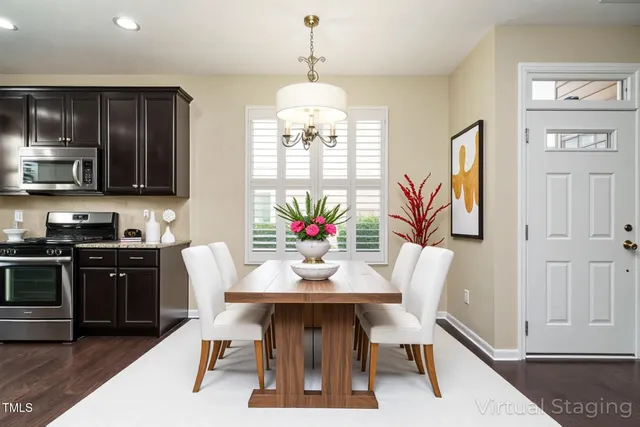 a kitchen with granite countertop stainless steel appliances a refrigerator cabinets and wooden floor