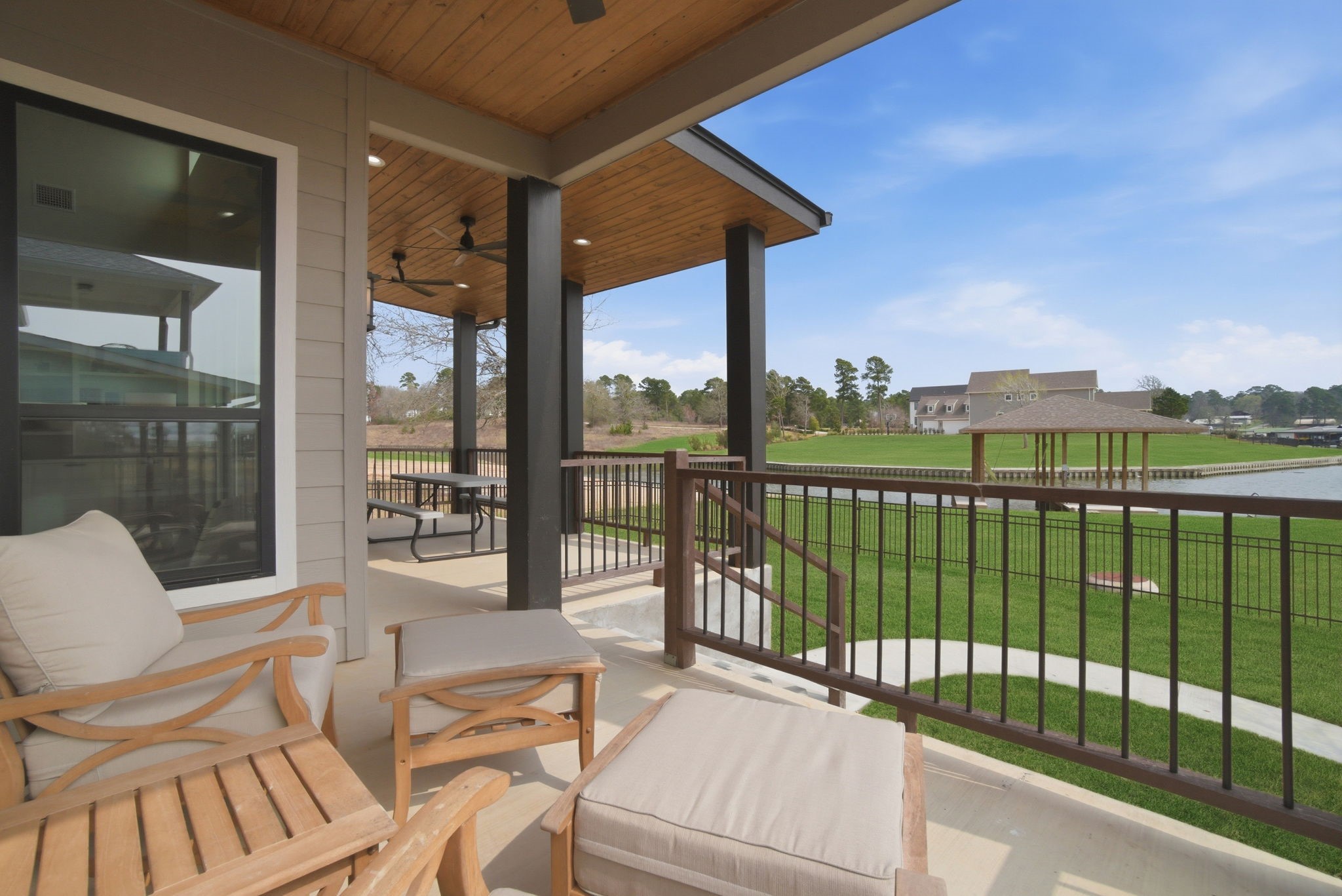 255 Peninsula Drive Livingston, TX 77351 - Photo 44 of 50 Beautiful view from one of the two patios provide ample room to relax or entertain as you take in the view, while the three ceiling fans in the custom wood porch ceiling keep you
and your guests cool.