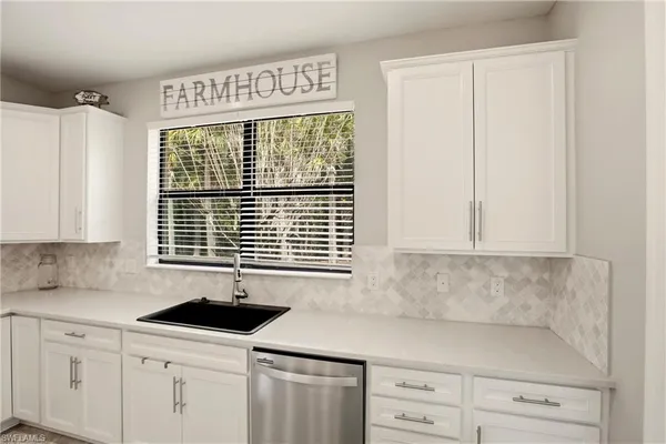 a kitchen with stainless steel appliances granite countertop a sink and a stove