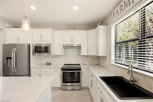 a kitchen with stainless steel appliances a refrigerator sink and cabinets