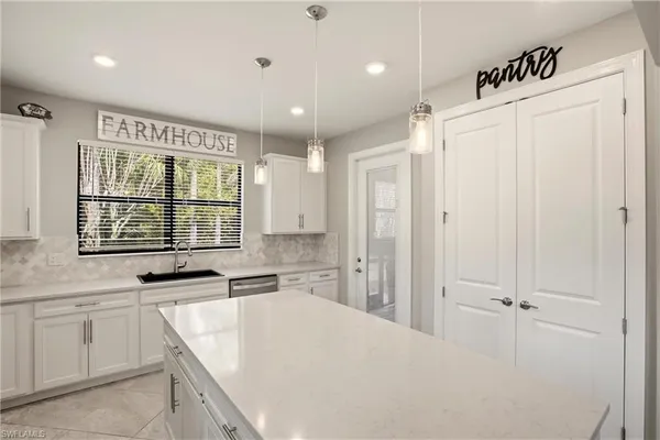 a kitchen with stainless steel appliances a stove a sink and a microwave