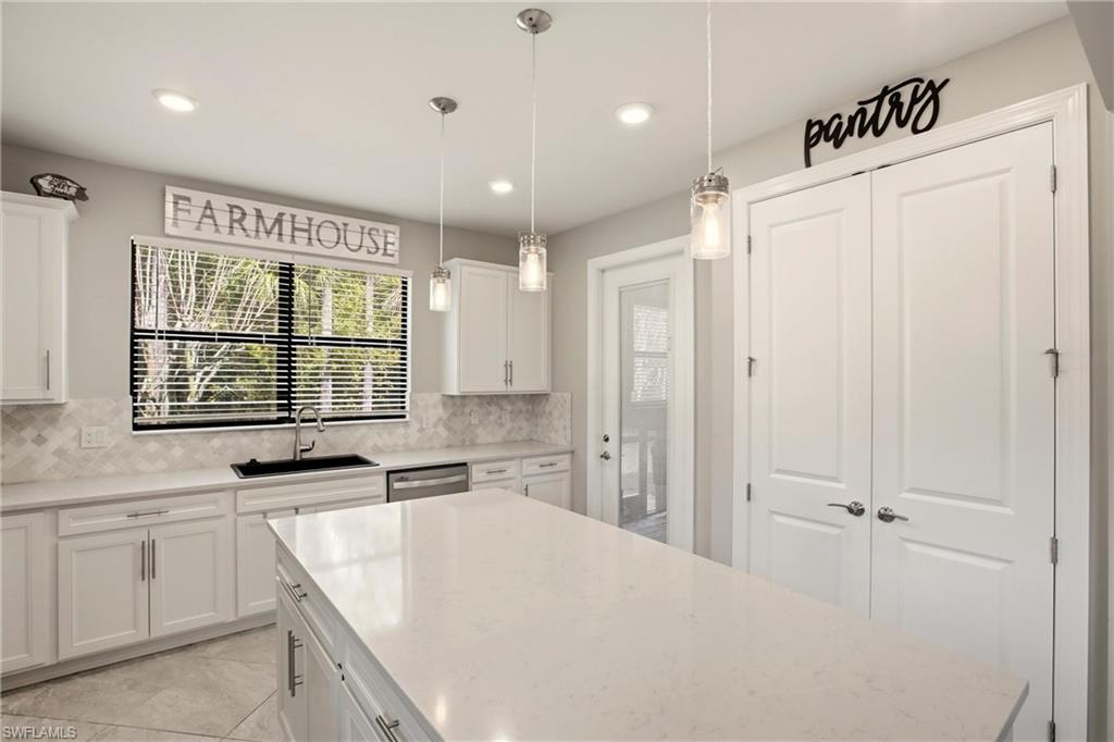 11216 Carlingford Road Fort Myers, FL 33913 - Photo 14 of 38 a kitchen with stainless steel appliances a refrigerator sink and cabinets
