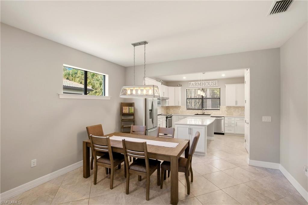 11216 Carlingford Road Fort Myers, FL 33913 - Photo 16 of 38 a view of a dining room with furniture and a chandelier