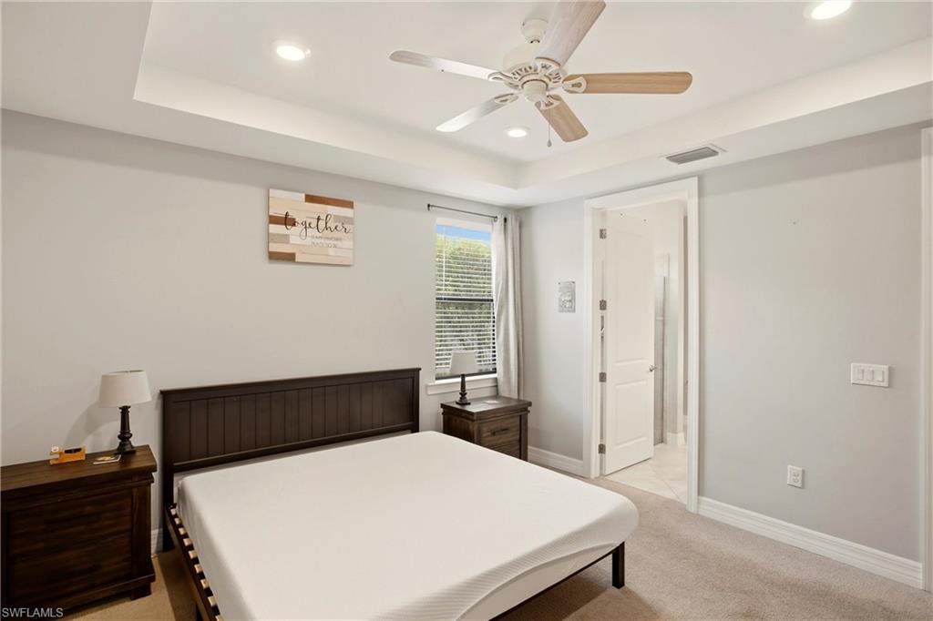 11216 Carlingford Road Fort Myers, FL 33913 - Photo 19 of 38 a bedroom with a bed and a chandelier