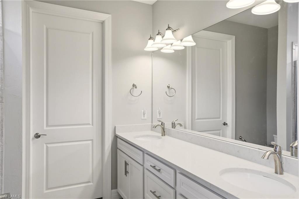 11216 Carlingford Road Fort Myers, FL 33913 - Photo 22 of 38 a bathroom with a sink vanity and a mirror