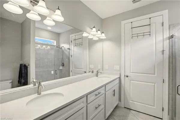 a bedroom with a bed and painting on the wall